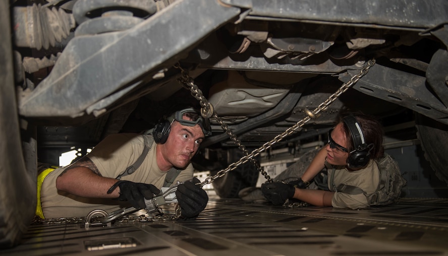 Senior Airman Cole Seelen, left, and Airman 1st Class Holly Cooper, both from the 921st Contingency Response Squadron, strap down a Humvee during exercise Mobility Guardian at Moses Lake, Wash., Aug. 5, 2017. The 621st Contingency Response Wing deployed an air base opening team of 99 Contingency Response Airmen in support of Air Mobility Command’s premier readiness exercise Mobility Guardian. (U.S. Air Force photo/Staff Sgt. Robert Hicks)
