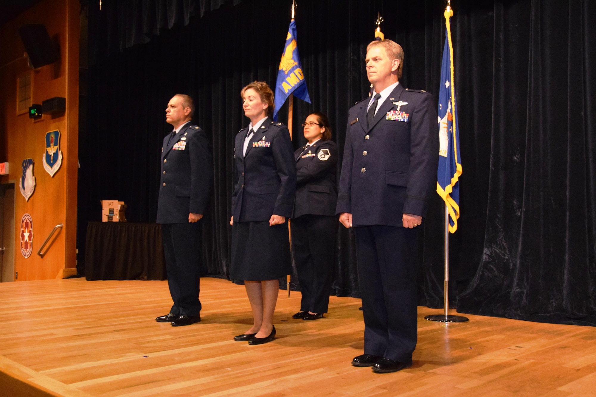 Col. Paul B. Deschner (right), the new 433rd Aerospace Medicine Squadron commander, prepares to take the reins of squadron leadership from Col. Ernest Vasquez, 433rd Medical Group commander, (far left), and Col. Julianne Flynn, (center),  during a change of command ceremony at Joint Base San Antonio-Lackland, Texas,  Aug. 6, 2017.