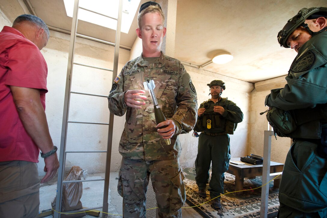 Soldier holding a mock mortar round.