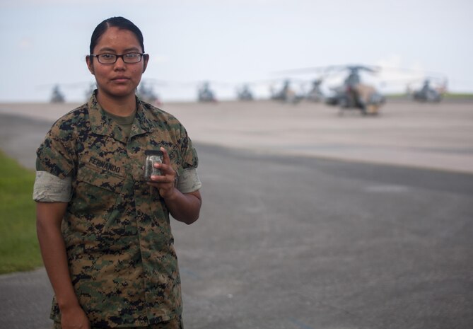 Lance Cpl. Jeanette E. Fernando holds a jar of sand taken from her trip to Iwo Jima, August 1, 2017, at Marine Corps Air Station Futenma, Okinawa, Japan.