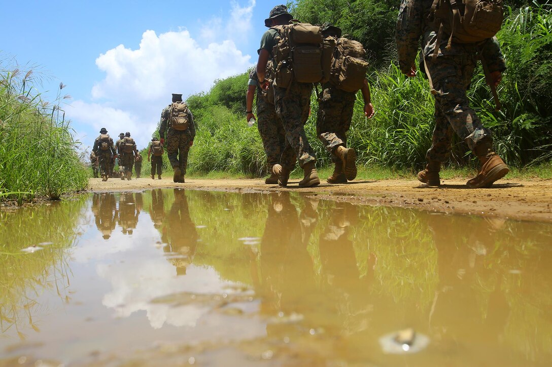 Lance Cpl. Jeanette E. Fernando and other Marines with Marine Light Attack Helicopter Squadron 169, hike towards the Iwo Jima memorial site on Mt. Suribachi, Iwo Jima, Japan, July 26, 2017.