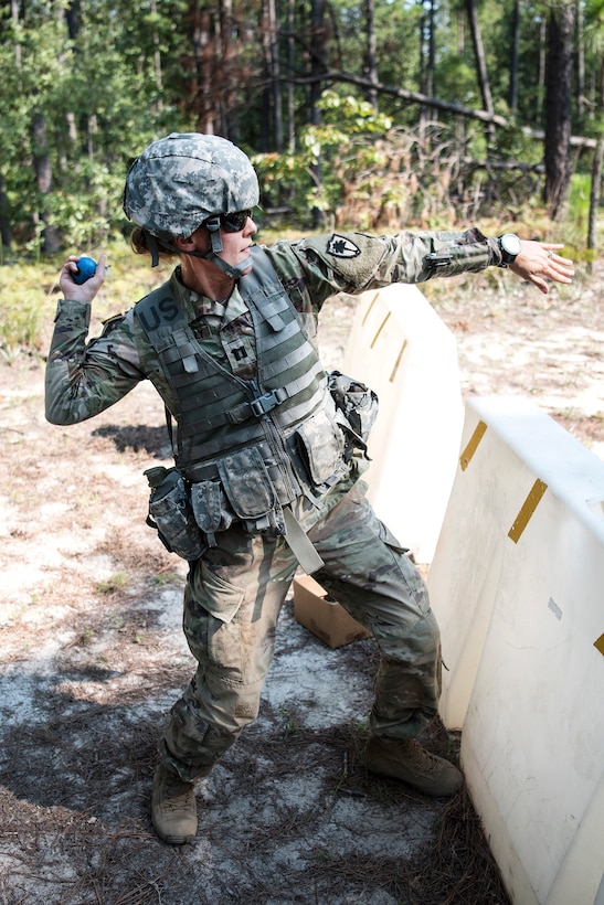 A soldiers prepares to throw a simulated hand grenade at a target during pre-deployment training.