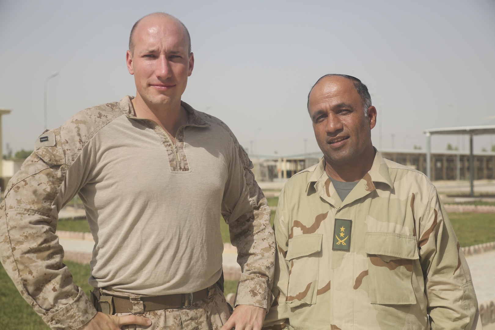 U.S. Marine Capt. Robert Walters, left, an advisor with Task Force Southwest, and Afghan National Army Lt. Col. Mirzashah Sadaq, right, the air officer of the 215th Corps, pose for a photo at Camp Shorabak, Afghanistan, Aug. 5, 2017. On July 24, two Mi-17s completed a casualty evacuation in the Nawa district of Helmand province in support of Operation Maiwand Four. Afghan National Army soldiers with 215th Corps successfully planned and prepared for potential CASEVACs during the operation with assistance and support from U.S. Marine advisors assigned to Task Force Southwest. The Afghan forces extracted the wounded soldier from the battlefield within an hour of notification, which allowed for quicker medical care and saved the soldier’s life. (U.S. Marine Corps photo by Sgt. Lucas Hopkins)