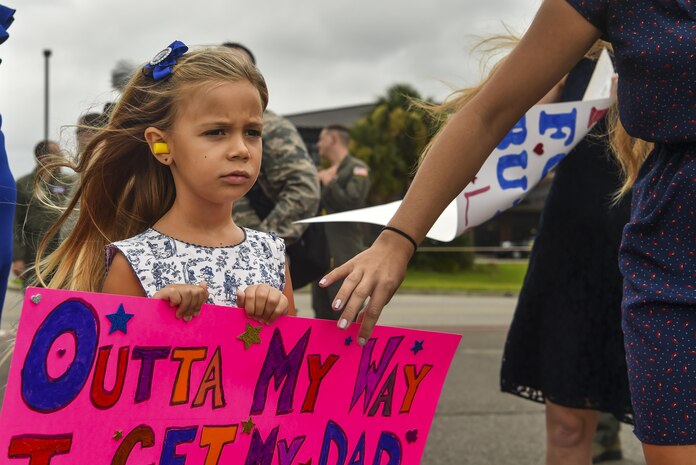 Hailey Fatjo, daughter of a returning deployer, walks towards the flightline to greet him with her mother at Joint Base Charleston, S.C., Aug. 8, 2017.