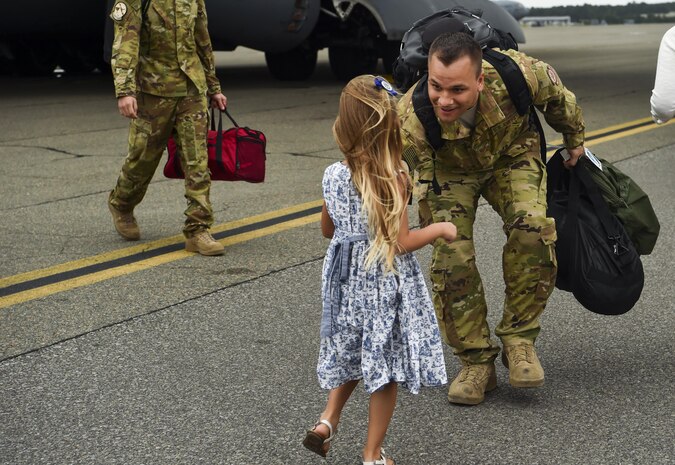 Tech. Sgt. Jason Fatjo, 14th Airlift Squadron loadmaster, greets his daughter after returning from a deployment at Joint Base Charleston, S.C., Aug. 8, 2017.