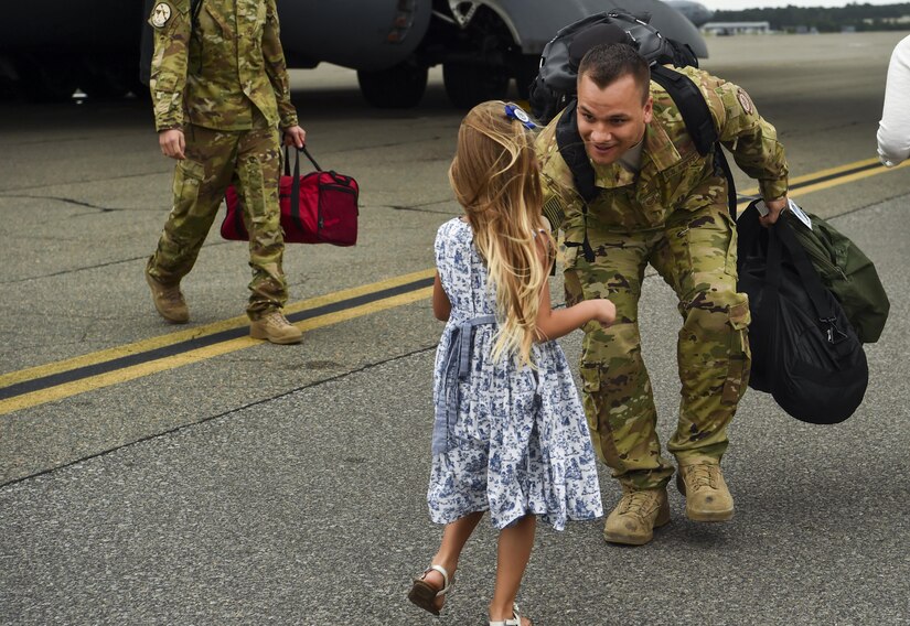 Tech. Sgt. Jason Fatjo, 14th Airlift Squadron loadmaster, greets his daughter after returning from a deployment at Joint Base Charleston, S.C., Aug. 8, 2017.