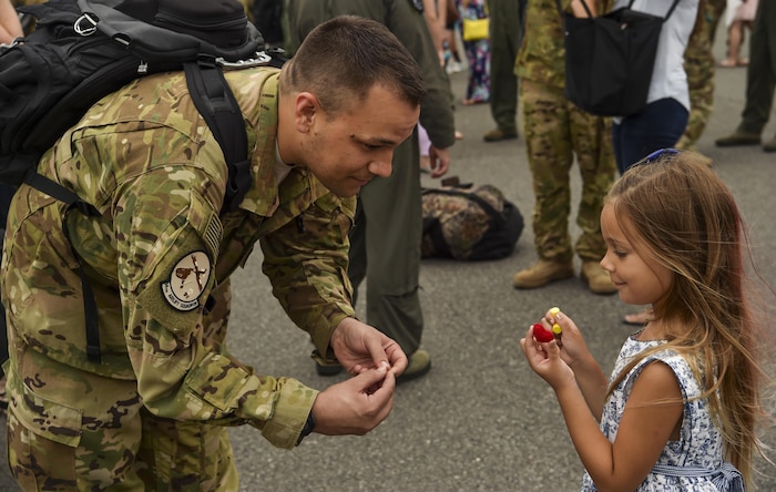 Tech. Sgt. Jason Fatjo, 14th Airlift Squadron loadmaster, and his daughter, Hailey, show each other their hearts after his return from deployment at Joint Base Charleston, S.C., Aug. 8, 2017.