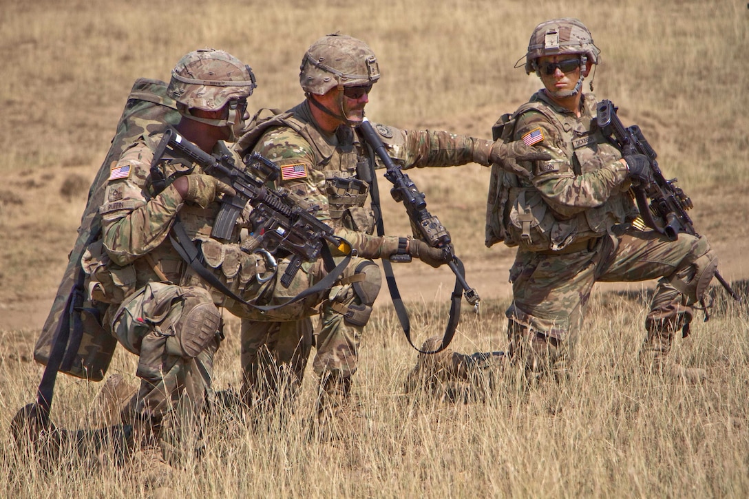 Soldiers take a knee while participating in a dismounted patrol.