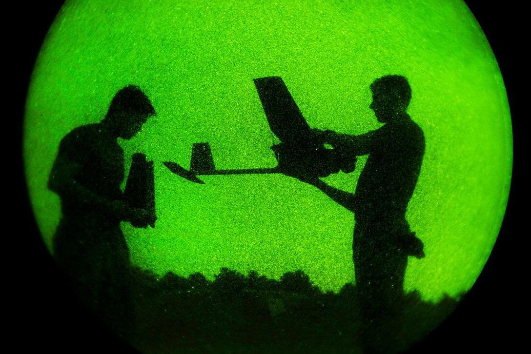 Soldiers perform a pre-flight checklist before launching an RQ-11 Raven.