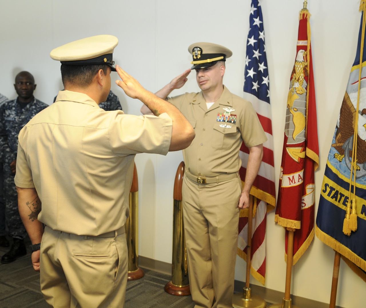 Navy Ensign Charles Wilton receives his first salute