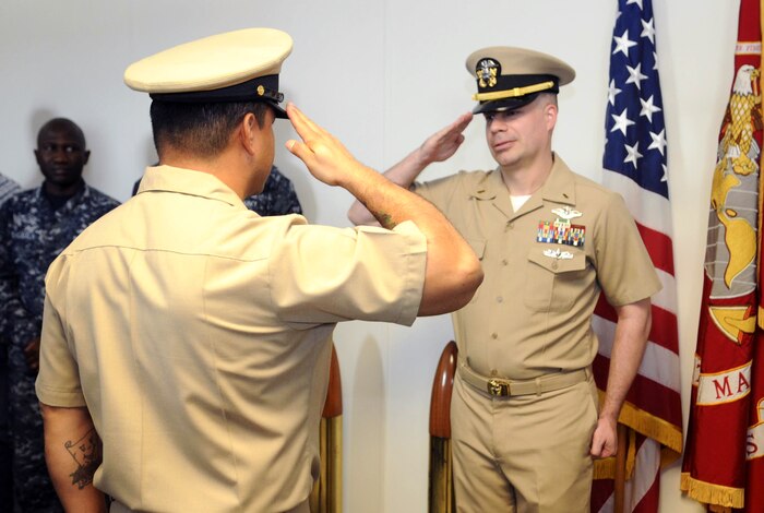 A Sailor salutes during commissioning ceremony.