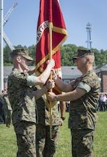 U.S. Marine Corps Lt. Col. Robert E. Cato II, outgoing commanding officer for Security Battalion (SECBN) presents the organizational colors to Lt. Col. Mark T. Schnakenberg, incoming commanding officer, during a change of command ceremony held at Lejeune Field, Marine Corps Base Quantico, June 21, 2017. The ceremony was held to transition command from Cato to Shnakenberg. (U.S. Marine Corps photo by: Lance Cpl. Micha R. Pierce)