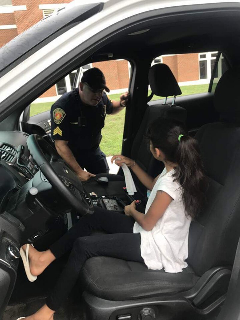 Officer explaining to a young motivator about the vehicles that we utilize at Security Battalion for Police and Firefighter Storytime on July 28th.