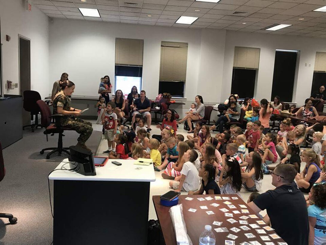 Cpl Cash, Military Police for PMO, reading to the boys and girls at Ellis Hall for the Police and Firefighter Storytime.