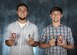 Jeremiah Treadwell, left, and his brother Benjamin, right, show off the coins and patches they received during their Joint Base Charleston tour.