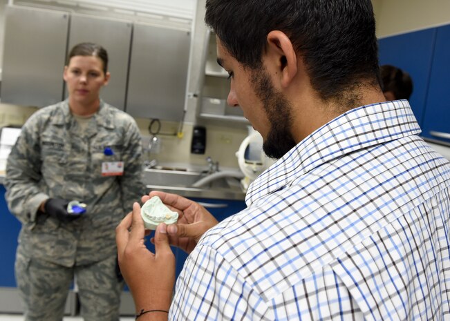 Jeremiah Treadwell looks at a dental mold during a tour of the Deily Dental Clinic July 27.