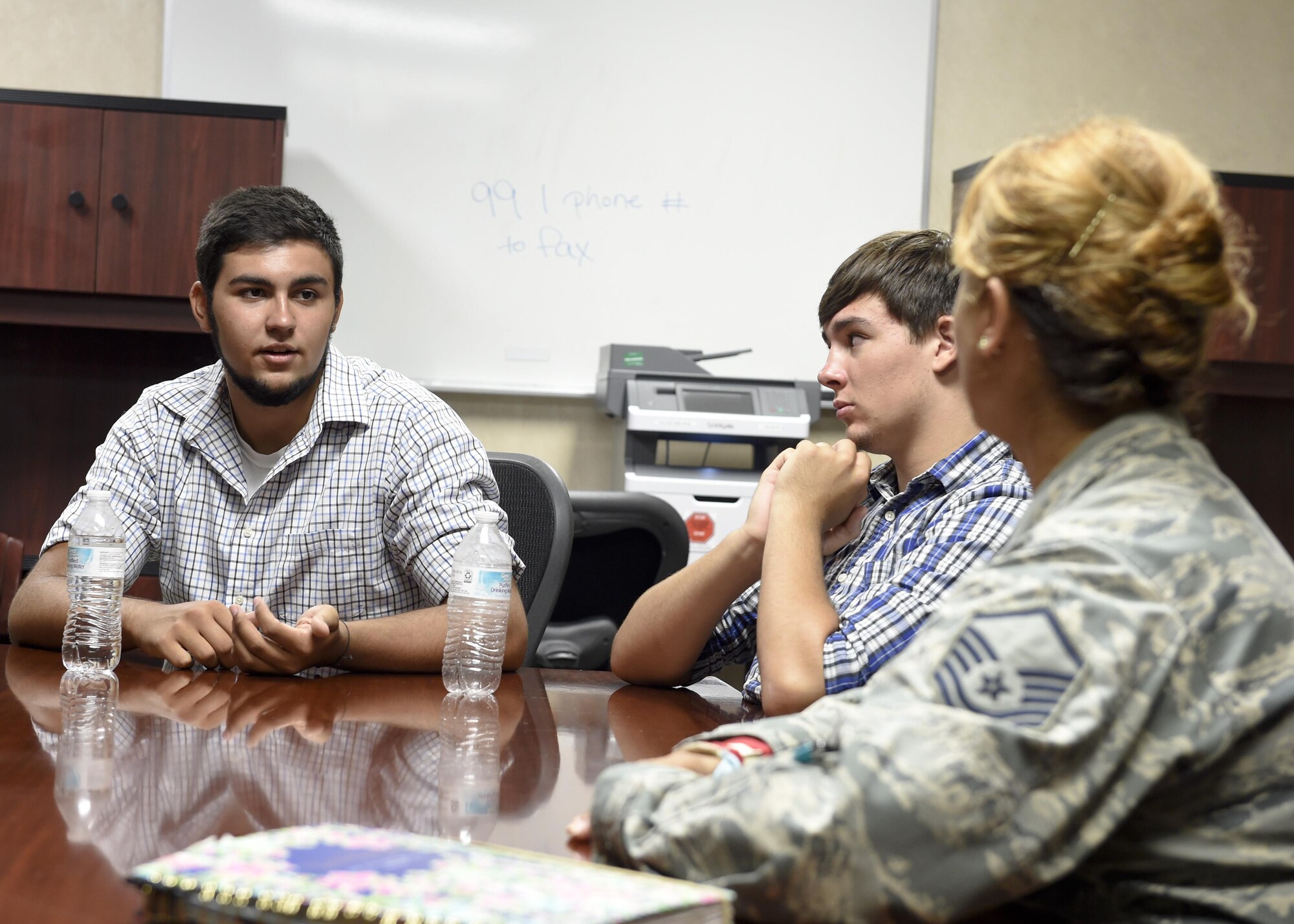 Jeremiah Treadwell, left, and his brother Benjamin, middle, discuss their interest in joining the military with Master Sgt. Caroline Bunce, 628th Aerospace Medical Squadron dental hygienist, during a tour of the Deily Dental Clinic July 25.