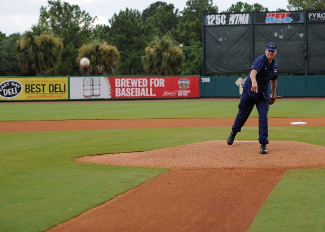U.S. Coast Guard Capt. Gregory Stump, Coast Guard Sector Charleston commander, throws a ceremonial first pitch during the Charleston RiverDogs Military Appreciation Night at Joseph P. Riley Jr. Park, Aug. 3, 2017.