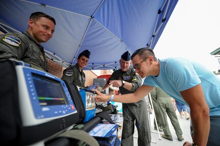 Robert Brittingham, U.S. Air Force veteran, left, learns about medical equipment from the 315th Aeromedical Evacuation Squadron during the Charleston RiverDogs Military Appreciation Night at Joseph P. Riley Jr. Park, Aug. 3, 2017.