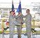 Lt. Col. David Hoffman, right, becomes director of the Flight Systems Combined Test Force (TSTW) during a Change of Directorship ceremony July 21 inside the Model Installation Building, part of the Propulsion Wind Tunnel Test Facility, at Arnold Air Force Base, Tennessee. Col. Timothy West, (left) chief of the AEDC Test Operations Division, passes the TSTW guidon to Hoffman as 1st Lt. Roy Fisher, looks on. The Flight Systems CTF provides aerodynamic ground-test capabilities from low subsonic to hypersonic speeds in various wind tunnels and supports Department of Defense, U.S. industry and international aerospace programs. (U.S. Air Force photo/Rick Goodfriend)