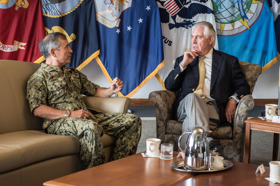 An admiral speaks with the U.S. secretary of state at a command's headquarters.