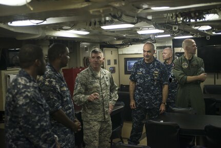 U.S. Navy Vice Adm. Charles Richard (center right), deputy commander of U.S. Strategic Command (USSTRATCOM), and U.S. Air Force Chief Master Sgt. Patrick McMahon (center left), USSTRATCOM senior enlisted leader, speak to sailors aboard USS Alaska (SSBN 732) during a visit to Naval Submarine Base Kings Bay, Ga., Aug. 3, 2017. While there, Richard and McMahon presented the 2016 Omaha Trophy, ballistic missile submarine category, to leaders and crew members of USS Alaska in recognition of their contributions to strategic deterrence. The Omaha Trophy, which dates back to the U.S. Air Force's Strategic Air Command, was originally created by the Strategic Command Consultation Committee in 1971. At the time, a single trophy was presented the organization’s best wing. The tradition later evolved to five awards that recognize USSTRATCOM’s premier intercontinental ballistic missile wing, ballistic missile submarine, strategic bomber wing, global operations (space/cyberspace) unit and strategic aircraft wing.