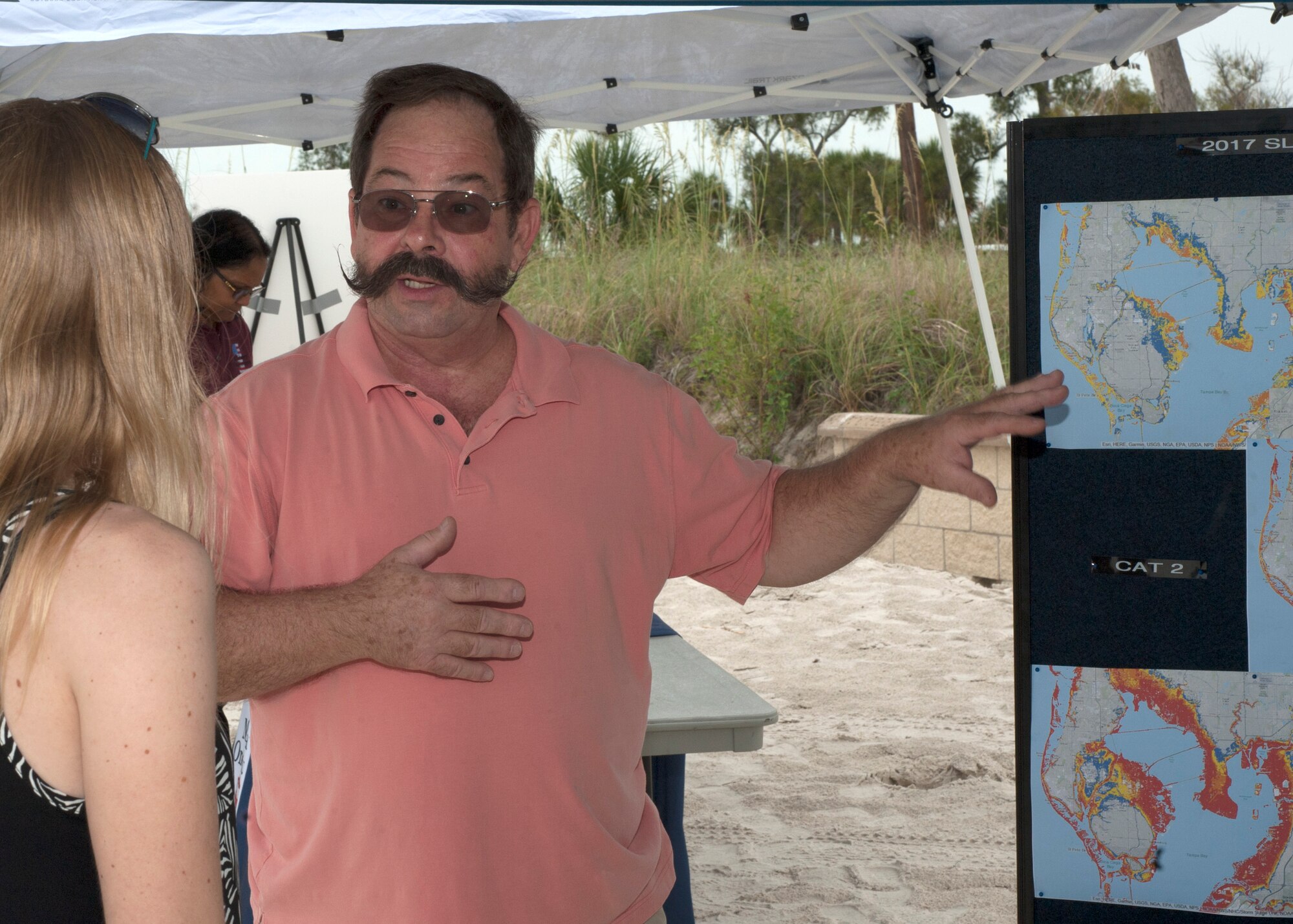 Mr. Leighton Reid, an Emergency Management Technician assigned to the 6th Civil Engineer Squadron (CES), discusses worse-case scenario hurricane storm surges with a U.S. Marine Forces Central Command Family Day attendee at MacDill Air Force Base, Fla., June 2, 2017