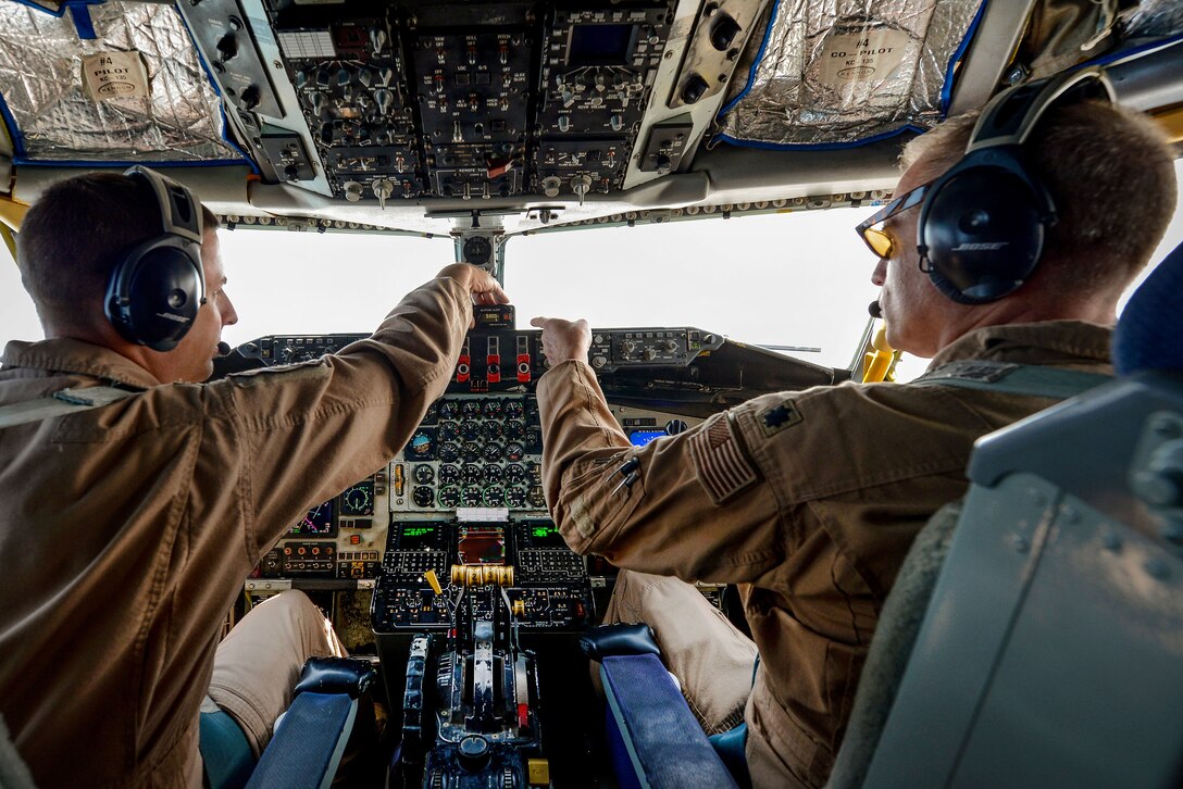 Air Force pilots perform a systems check during a flight.