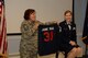 U.S. Air National Guard Chief Master Sgt. Josephine A. Iennaco, the 157th Medical Group superintendent, presents Senior U.S. Air National Guard Master Sgt. June Fonteyne, a health systems technician with the 157th MDG, a sweatshirt with her nickname and number of total years of service during her retirement ceremony August 5, 2017 at Pease Air National Guard Base, N.H.