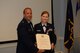 U.S. Air National Guard Lt. Col. Philip A. Plourde, the acting 157th Medical Group commander presents U.S. Air National Guard Senior Master Sgt. June E. Fonteyne, a health systems technician with the 157th MDG with her retirement certificate August 5, 2017 at Pease Air National Guard Base, N.H.