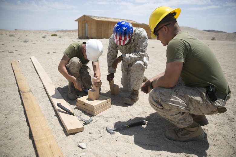 Marines with the engineer platoon for Marine Wing Support Squadron 272, construct a foundation for a Southwest Asia hut aboard the Combat Center during Integrated Training Exercise 5-17, July 29, 2017. MWSS-272 is supporting the Aviation Combat Element of the ITX. The ACE conducts offensive, defensive, and all other air operations to support the MAGTF mission . (U.S. Marine Corps photo by Cpl. Medina Ayala-Lo)
