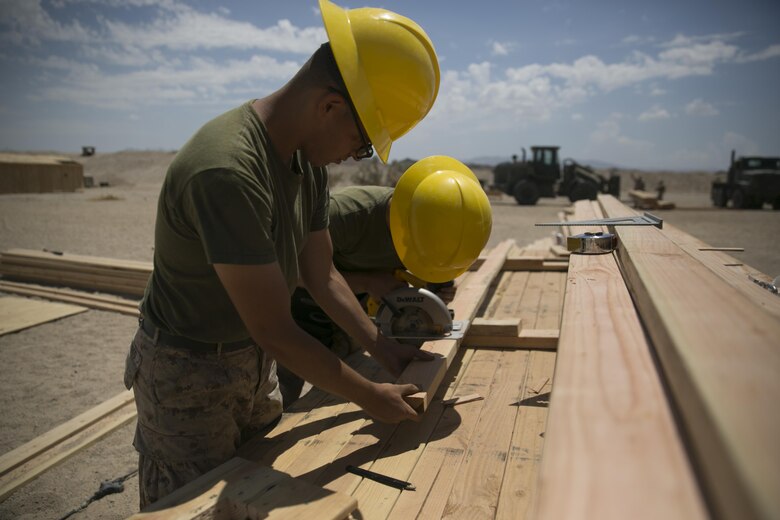 Marines with the engineer platoon for Marine Wing Support Squadron 272, cut wood for a Southwest Asia hut aboard the Combat Center during Integrated Training Exercise 5-17, July 29, 2017. MWSS-272 is supporting the Aviation Combat Element of the ITX. The ACE conducts offensive, defensive, and all other air operations to support the MAGTF mission . (U.S. Marine Corps photo by Cpl. Medina Ayala-Lo)