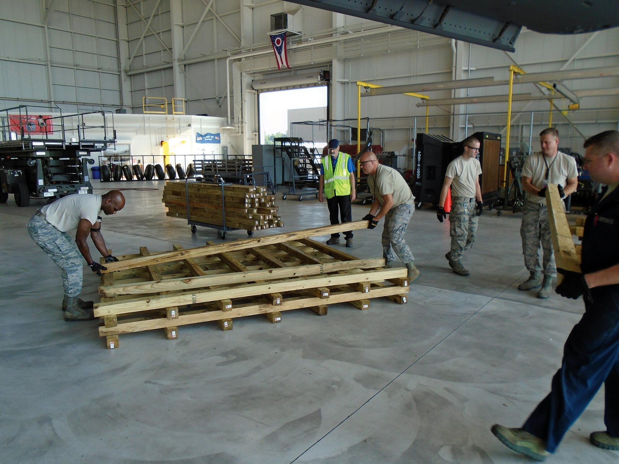 Members of the 445th Maintenance Group Crash Damage or Disabled Aircraft Recovery (CDDAR) Team begin construction of cribbing for a simulated wing lift July 17, 2017. (U.S. Air Force photo/Master Sgt. Patrick O’Reilly)