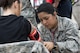 Airman Gabriela Vazquez, 88th Medical Group medical technician, checks the vitals of Airman 1st Class Taylor Osborne, 88th Aerospace Medical Squadron biological environmental engineering technician, during a base exercise at Wright-Patterson Air Force Base, Ohio, Aug. 4, 2017. Readiness exercises are routinely held to streamline unit cohesion when responding to emergencies. (U.S. Air Force photo by Wesley Farnsworth/Released)