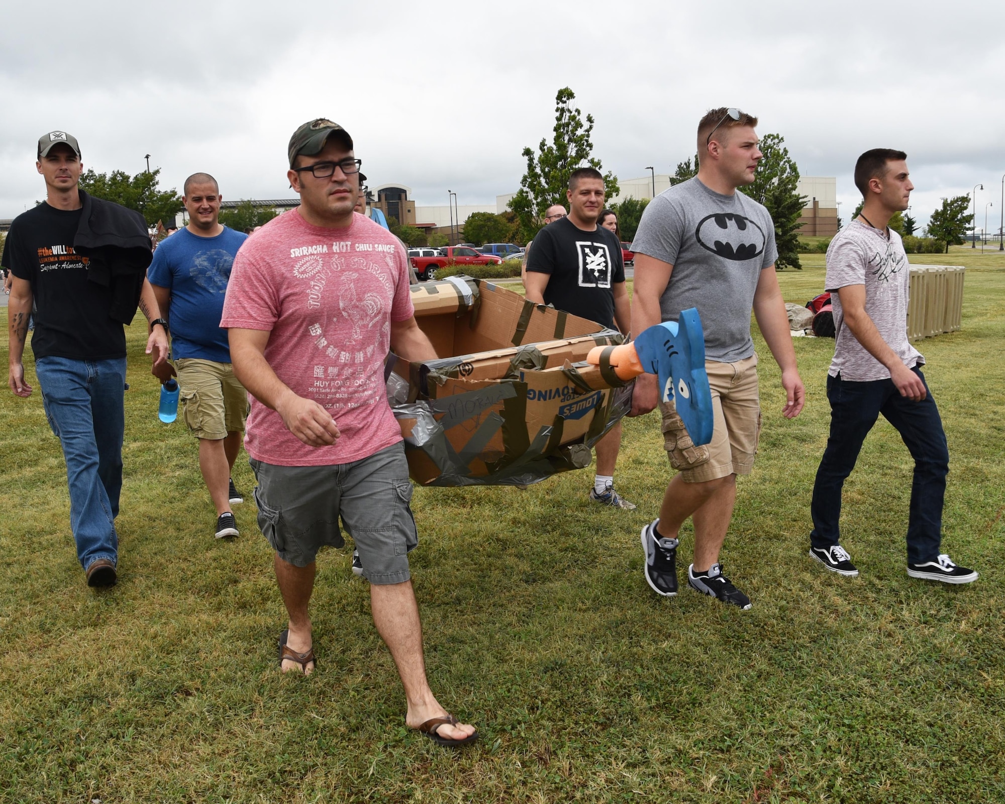 Airmen from the 931st Maintenance Group carry their cardboard "boat" to the base pool during Wingman Day, Aug. 6, 2017, at McConnell Air Force Base, Kan.  Airmen were divided into their units and constructed cardboard boats as a team building exercise. The day concluded with a race in the base pool.  (U.S. Air Force photo by Tech. Sgt. Abigail Klein)