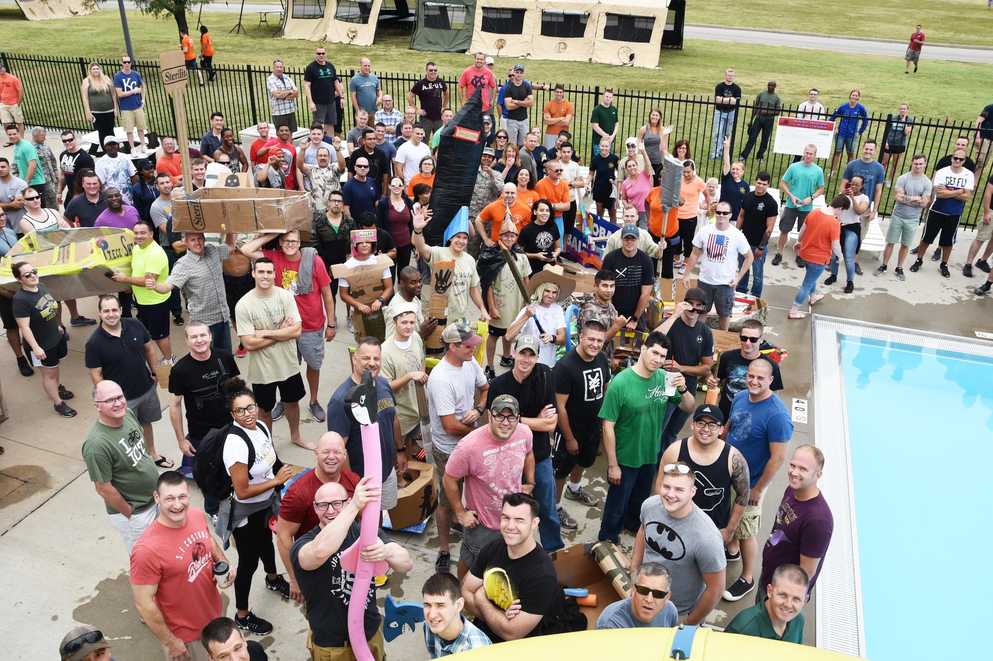 Airmen of the 931st Air Refueling Wing gather before a "boat" race at the base pool during Wingman Day 2017, Aug. 6, 2017, at McConnell Air Force Base, Kan. Wingman Day is designated by the Air force to allow leadership to set aside a day to focus on the Airman and comradery. during the event, Airmen were divided into their units and constructed cardboard boats as a team building exercise. (U.S. Air Force photo by Tech. Sgt. Abigail Klein)