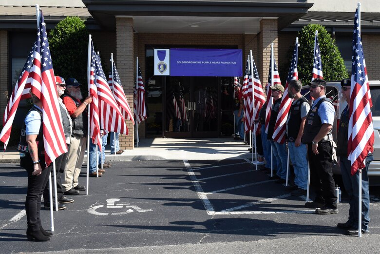 Volunteers present American flags at the entrance to the Goldsboro/Wayne Purple Heart Foundation Purple Heart banquet, Aug. 4, 2017, in Goldsboro, North Carolina.