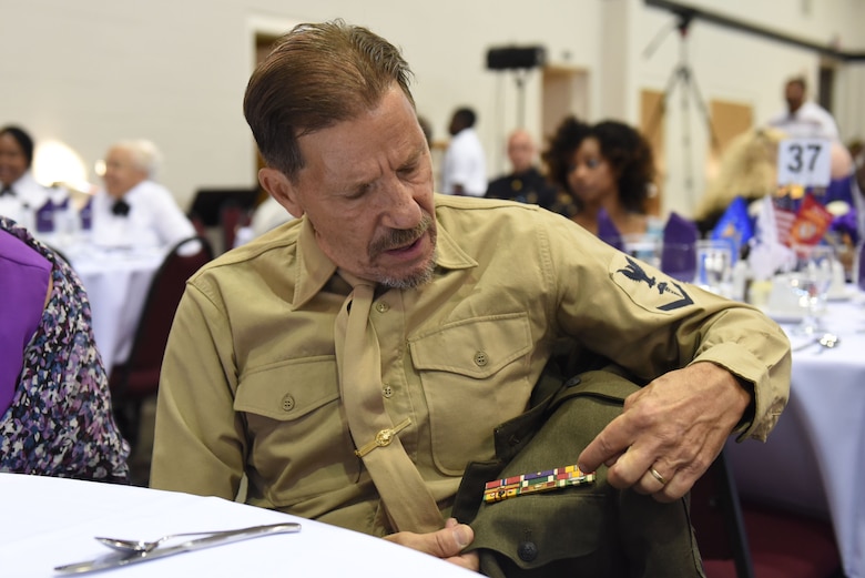 Jack Hanley, Purple Heart recipient, explains each decoration on his uniform, Aug. 4, 2017, at the Goldsboro/Wayne Purple Heart Foundation Purple Heart banquet in Goldsboro, North Carolina.