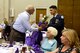 John Lane (left), a Gold Star brother, receives a bouquet of flowers and a gift bag presented by a Junior ROTC cadet, Aug. 4, 2017, at the Goldsboro/Wayne Purple Heart Foundation Purple Heart banquet in Goldsboro, North Carolina. A Gold Star family member is someone whose family member was killed in combat while serving in the Armed Forces. (U.S. Air Force photo by Airman 1st Class Victoria Boyton)