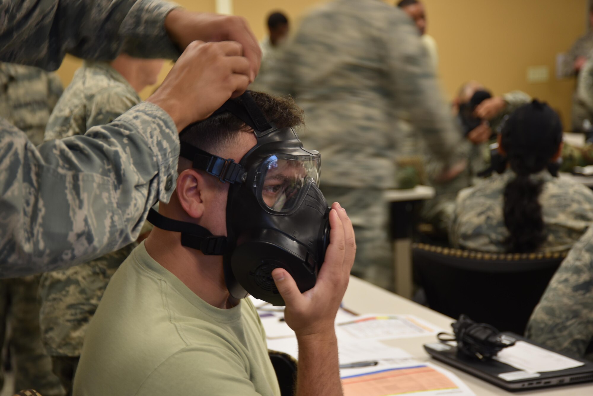 Airmen from the 301st Fighter Wing Mission Support Group prepare their gas masks to fit properly with an air-tight seal during an Ability to Survive and Operate (ATSO) training Saturday, Aug. 5, 2017 at Naval Air Station Fort Worth Joint Reserve Base, Texas. Annual exercises hone Airmen’s skills to continue executing the mission in austere conditions. (U.S. Air Force photo/ Tech. Sgt. Jeremy Roman)