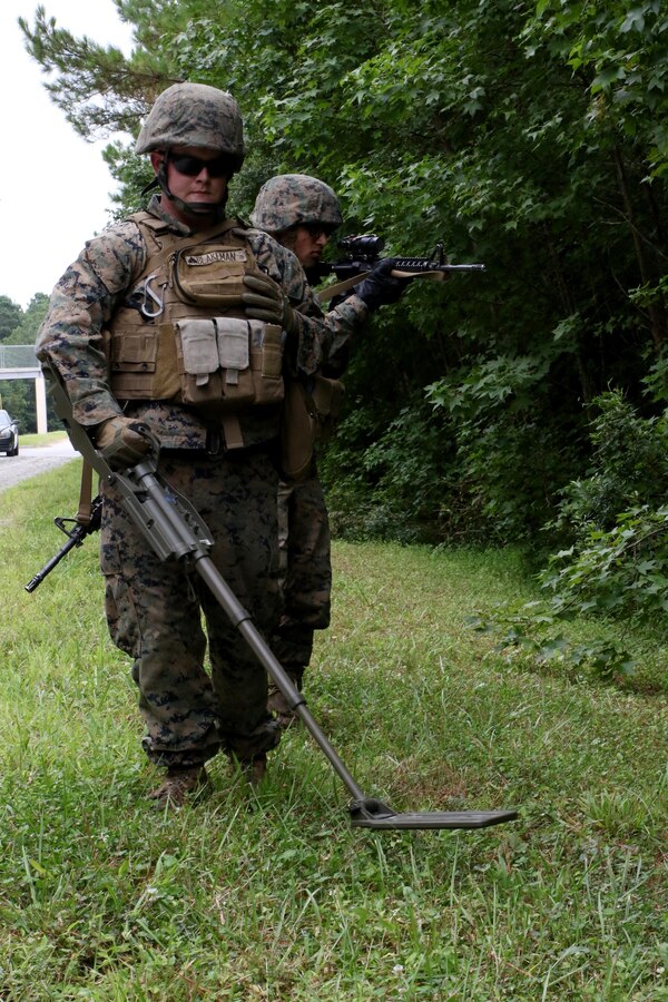 Cpl. Nathaniel Blakeman, left, sweeps for simulated improvised explosive devices and Pfc. Kevin Patel provides security during Marine Wing Support Squadron 271’s Counter-IED training at Marine Corps Base Camp Lejeune, N.C., Aug. 3, 2017. The weeklong training taught Marines to safely operate in an environment with a known IED threat, and respond to potential IEDs if they were detected. Blakeman and Patel are motor transport operators assigned to MWSS-271, Marine Aircraft Group 14, 2nd Marine Aircraft Wing. (U.S. Marine Corps photo by Cpl. Jason Jimenez/ Released)