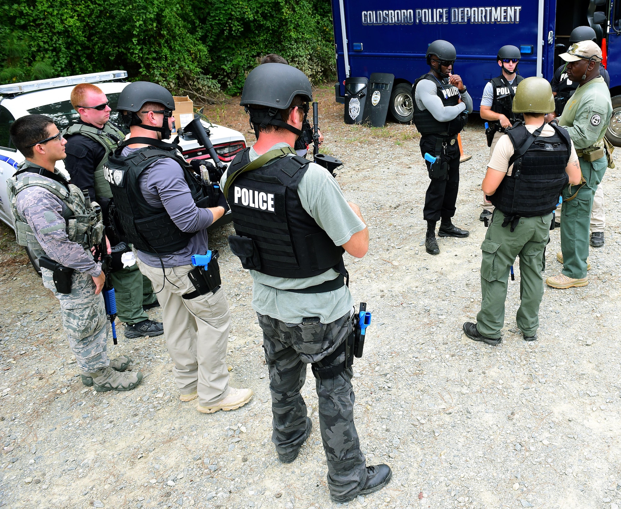 A.A. Boone, founder and president of Specialized Realistic Training Inc. (right), instructs students on the basic SWAT course before entering the shoot-house, Aug. 3, 2017, at Seymour Johnson Air Force Base, North Carolina.
