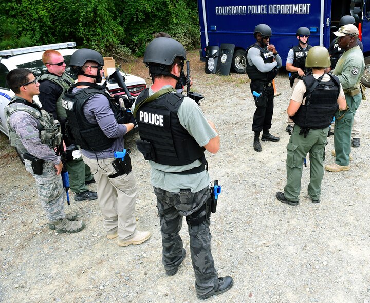 A.A. Boone, founder and president of Specialized Realistic Training Inc. (right), instructs students on the basic SWAT course before entering the shoot-house, Aug. 3, 2017, at Seymour Johnson Air Force Base, North Carolina.