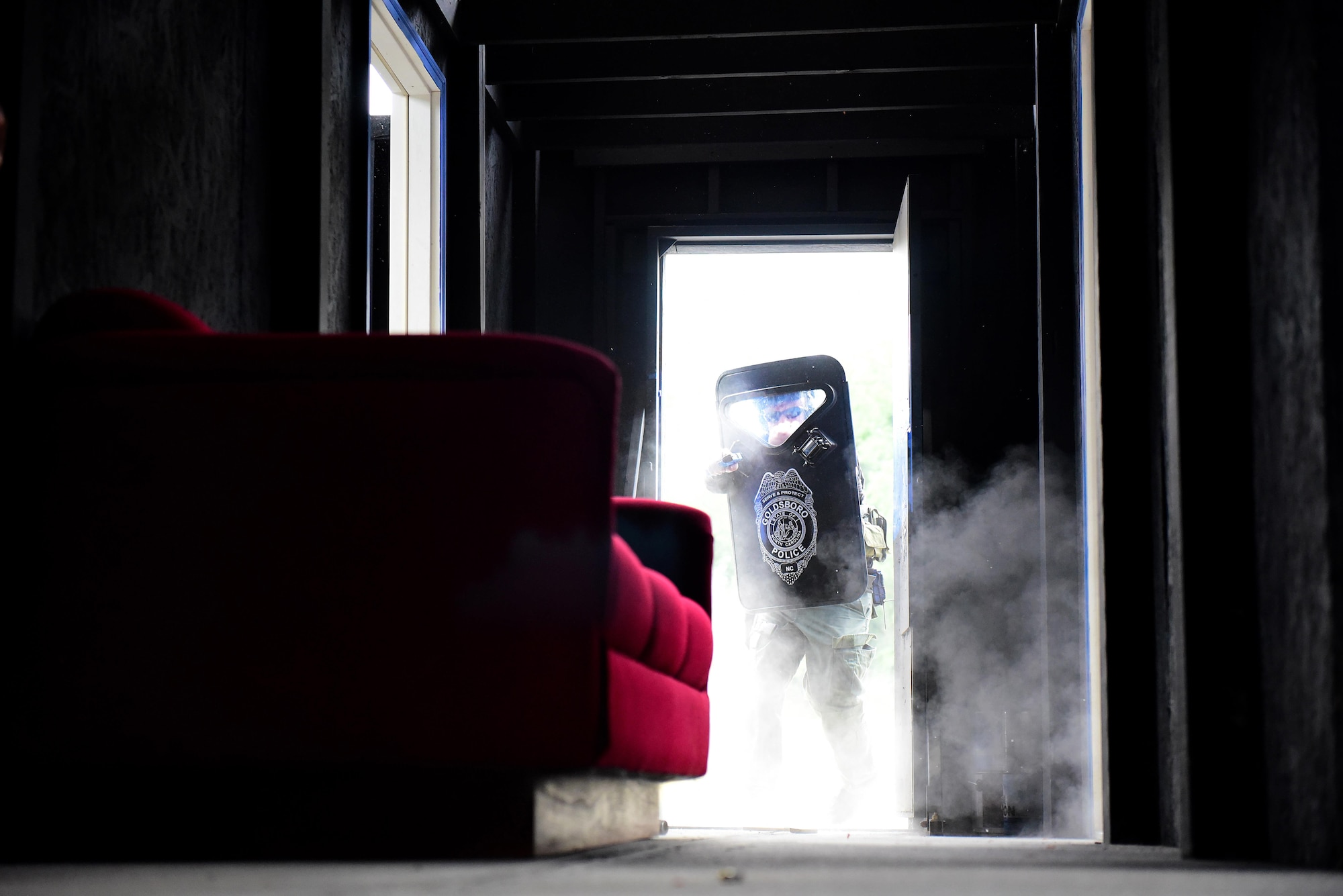 A Goldsboro Police Officer participating in a basic SWAT course uses a Glock and ballistic shield to enter a building simulating a hostile environment, Aug. 3, 2017, at Seymour Johnson Air Force Base, North Carolina.