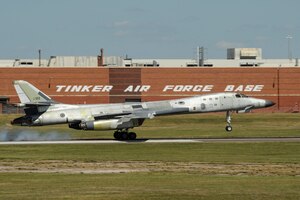A mostly natural metal Boeing B-1B Lancer is shown moments after the main landing gear tires have touched the runway at the end of a post-maintenance check-flight with the 10th Flight Test Squadron, Air Force Reserve Command, June 20, 2017, Tinker Air Force Base, Oklahoma.