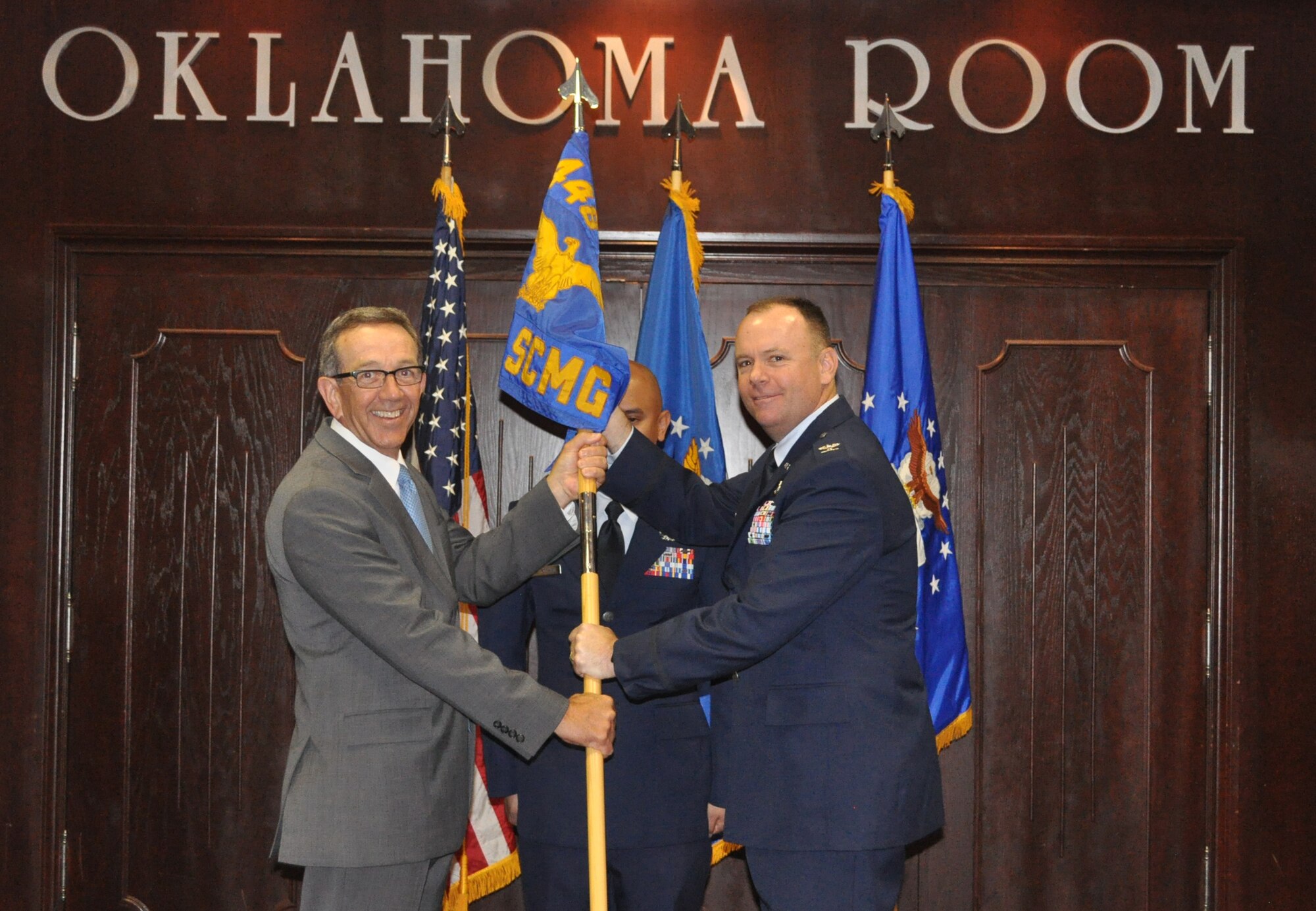 Col. Robert A. Kielty received the guidon from 448th Supply Chain Management Wing director Frank Washburn, as he assumed command of the 848th Supply Chain Management Group.
