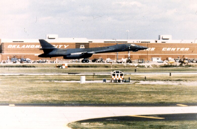 A B-1 lands at Tinker with Bldg. 3001 in the background.