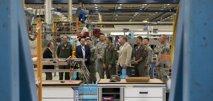 Defense contractors give a tour to airmen from the 366th Fighter Wing of Mountain Home Air Force Base, Idaho, during their visit to the factory Aug. 3, 2017, in St. Louis, Mo. Gunfighters toured the F-15E Strike Eagle production line and the weapons factory during their visit. (U.S. Air Force photo by Senior Airman Jeremy L. Mosier)