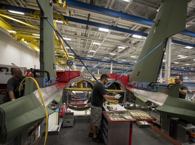 Defense contractor employees work on a portion of an F-15E Strike Eagle in a factory in St. Louis, Mo, Aug. 3, 2017. Workers were given the opportunity to meet with service members whom they produce products for. (U.S. Air Force photo by Senior Airman Jeremy L. Mosier)