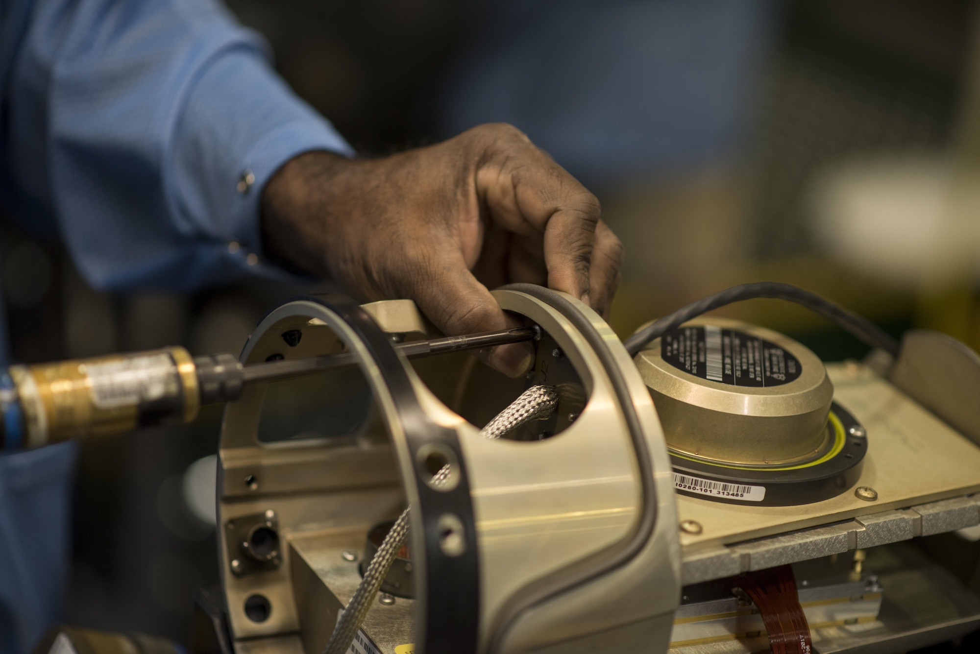 Keith Anderson, defense contractor munitions mechanic, installs a wiring harness to a munition Aug. 3, 2017, in St. Louis, Mo. While touring the munitions facility, Airmen from Mountain Home Air Force Base, Idaho, were able to see the munitions develop throughout the stages. (U.S. Air Force photo by Senior Airman Jeremy L. Mosier)